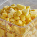 A container of diced pineapples on a counter.