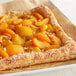 IQF sliced apricots on a square pastry with fruit on top.