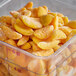 A plastic container of frozen sliced apricots.