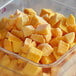 A container of frozen yellow mango cubes.
