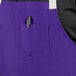 A purple Uncommon Chef Vibe apron with natural webbing and 3 pockets, one with a pen in it.