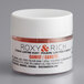 A white container of Roxy & Rich Carrot Lustre Dust with a white lid.