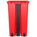 A red rectangular Continental trash can with black wheels.