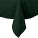 A hunter green rectangular tablecloth folded on a table.