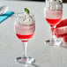 Two Acopa wine tasting glasses filled with desserts topped with whipped cream and mint.