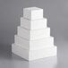 A stack of white square cake dummies.