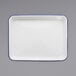 A white rectangular enamelware tray with blue trim.