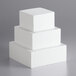 A stack of three white foam cubes.