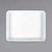 A white rectangular Crow Canyon Home enamelware tray with turquoise trim.