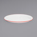 A white Crow Canyon Home enamelware platter with red trim.