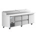 An Avantco stainless steel refrigerated pizza prep table with drawers on wheels.