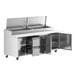 A stainless steel Avantco pizza prep table with 2 doors and 2 drawers on a stainless steel counter.