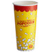 A white and yellow Carnival King paper cup filled with popcorn.