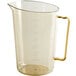 A Cambro high heat amber plastic measuring cup with gold handles.