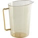 A clear plastic Cambro measuring cup with a gold handle and writing on the side.