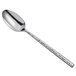 A Carlisle hammered stainless steel serving spoon with a handle.