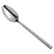 A Carlisle Terra hammered stainless steel serving spoon with a handle.