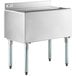 A Regency stainless steel underbar ice bin with sliding lid and bottle holders on a counter.