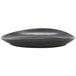 A black Front of the House Tides oval porcelain plate with a curved edge.