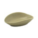 A close up of a Front of the House Tides semi-matte sea grass oval ramekin with a curved edge.