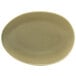 A close-up of a Front of the House Tides sea grass oval porcelain bowl with a brown rim.