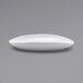 A close up of a white oval Front of the House Tides porcelain plate.