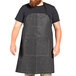 A man with a beard wearing a black denim Uncommon Chef apron.