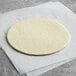 Pillsbury round frozen pie dough on a white surface.