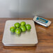 An Edlund digital receiving scale weighing limes on a table.
