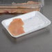 A white foam supermarket tray with white absorbent pads and raw meat on it.