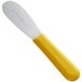 A yellow Dexter-Russell sandwich spreader with a white handle.