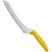 A Dexter-Russell bread knife with a yellow handle.