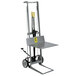 A grey hand truck with a yellow label.