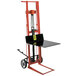 A red and black Wesco Industrial Products hydraulic Pedalift with a black table on top.