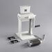 A white Backyard Pro meat tenderizer machine with a black handle.