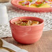 An Acopa Capri coral reef stoneware bouillon bowl filled with soup on a table.