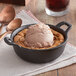 A Valor pre-seasoned cast iron bowl filled with ice cream on a table.