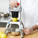 A person in white gloves using Vollrath Redco InstaCut 3.5 with Vollrath 15053 Redco 8 Section Wedge T-Pack to cut lemons.