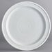 A Acopa Capri white stoneware plate with a circular pattern.