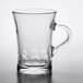 A clear glass Duralex espresso cup with a handle.