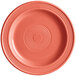 A close-up of an Acopa Capri coral stoneware plate with a spiral pattern in a pink circle.