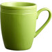 An Acopa Capri green stoneware mug with a handle.