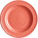 An Acopa Capri coral stoneware plate with a spiral pattern in pink.