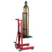 A red Wesco Industrial Products 4 wheel cart with a large metal cylinder on it.