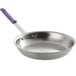 A Vollrath stainless steel fry pan with a purple allergen-free sleeve handle.