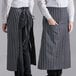 Two people wearing black and white striped Choice bistro aprons.