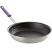 A Vollrath Wear-Ever non-stick aluminum fry pan with a purple handle.