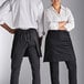 A man and woman wearing black Choice half bistro aprons.