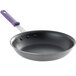 A Vollrath 10" stainless steel frying pan with a purple sleeve handle.