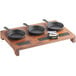 A Valor cast iron appetizer/dessert sampler display stand with three cast iron pans on a wooden tray.